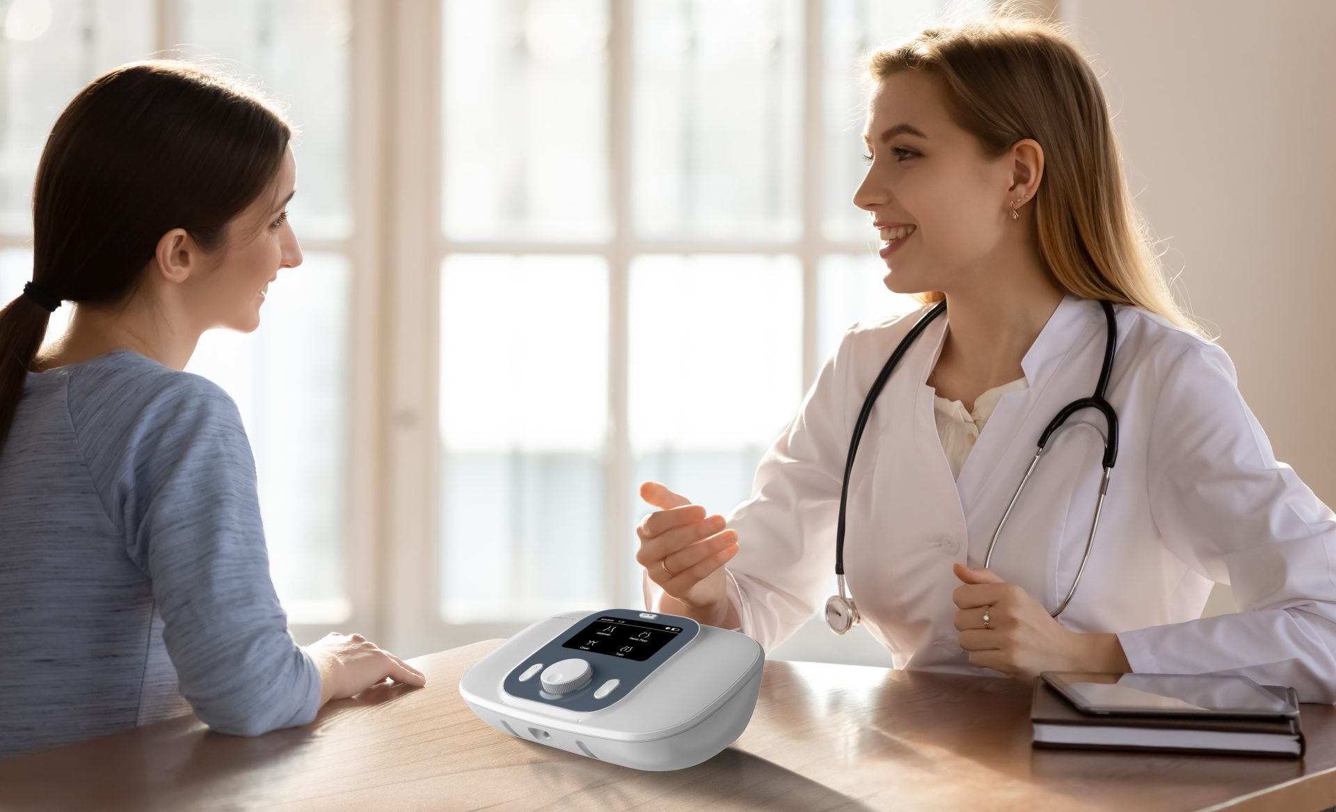 Doctor discussing an electrical therapy device with a female patient